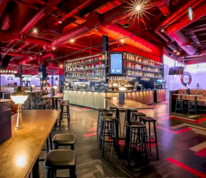 Image of a Puttshack venue's bar and high top tables