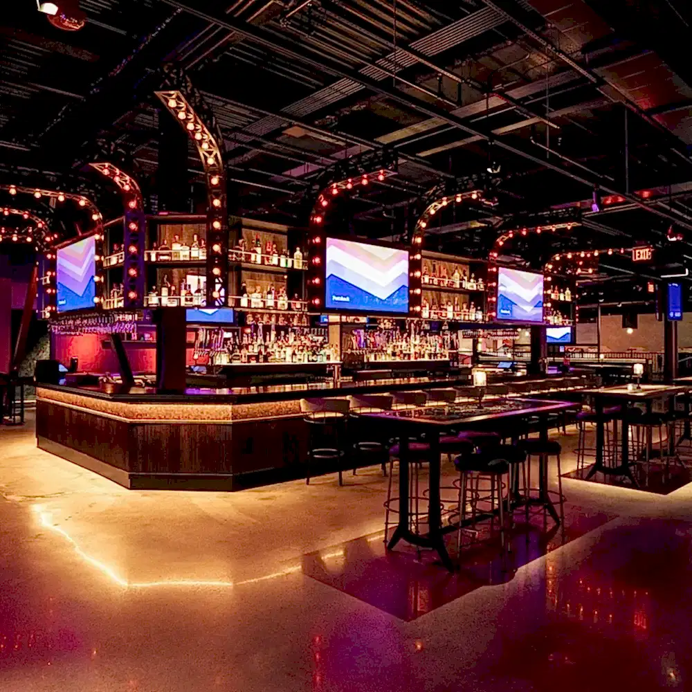 puttshack bar and tables with tvs